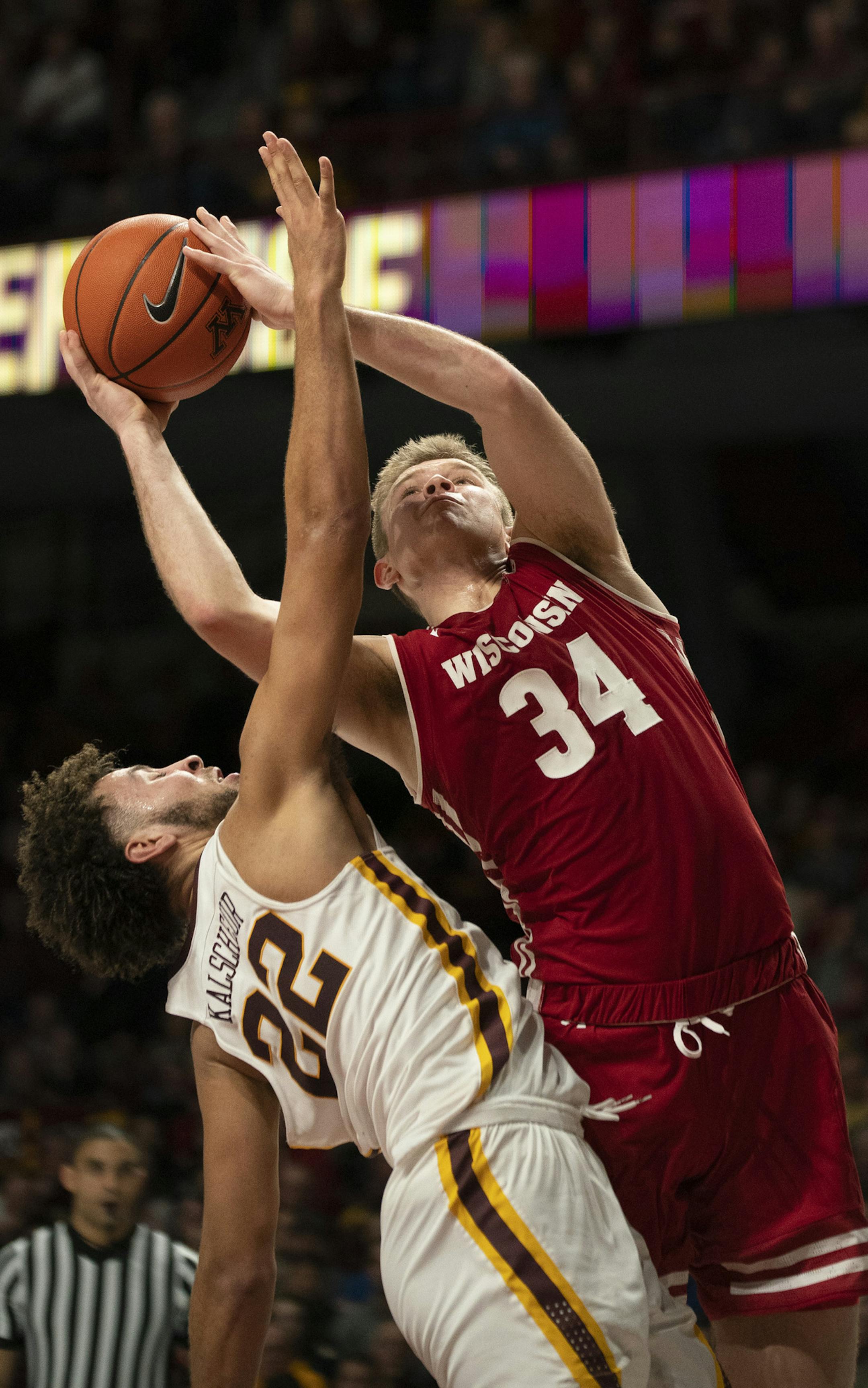 Gophers guard Gabe Kalscheur (22) fouled Badgers guard Brad Davison (34) as he drove to the net in the second half. ] JEFF WHEELER • jeff.wheeler@startribune.com The University of Minnesota men's basketball team lost to the University of Wisconsin Badgers 56-51 in an NCAA game Wednesday night, February 6, 2019 at Williams Arena in Minneapolis.