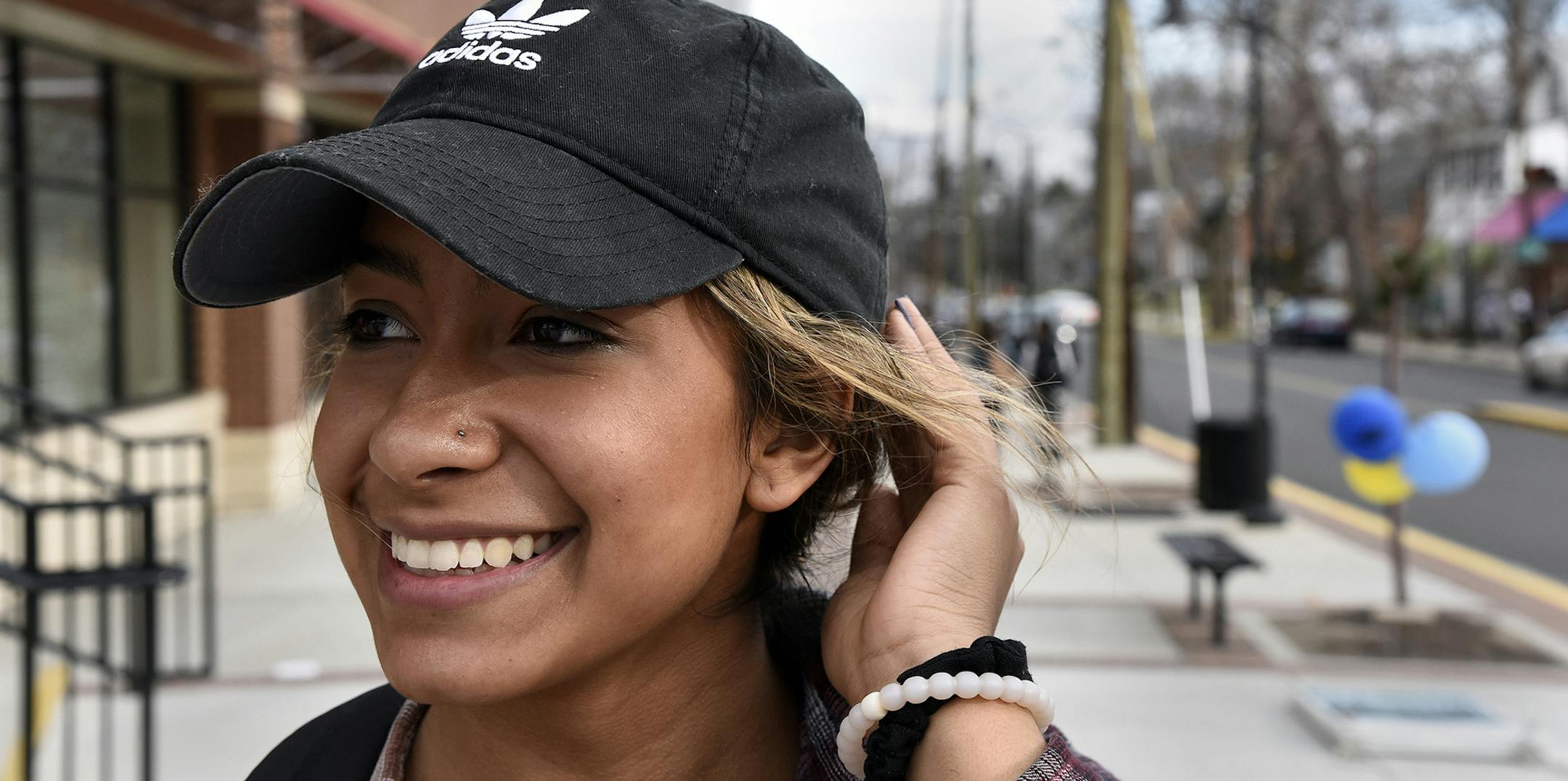 Keli Reyes, a UMD sophomore, wears an Adidas cap and Adidas athletic shoes on Feb. 8, 2017 in College Park, Md. Adidas brand athletic apparel and shoes are experiencing a "comeback" with the University of Maryland community. Stripe Three is a local store that features Adidas items. (Barbara Haddock Taylor/Baltimore Sun/TNS)