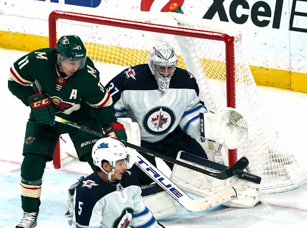 Wild left wing Zach Parise tipped this shot into the glove of Winnipeg goaltender Connor Hellebuyck