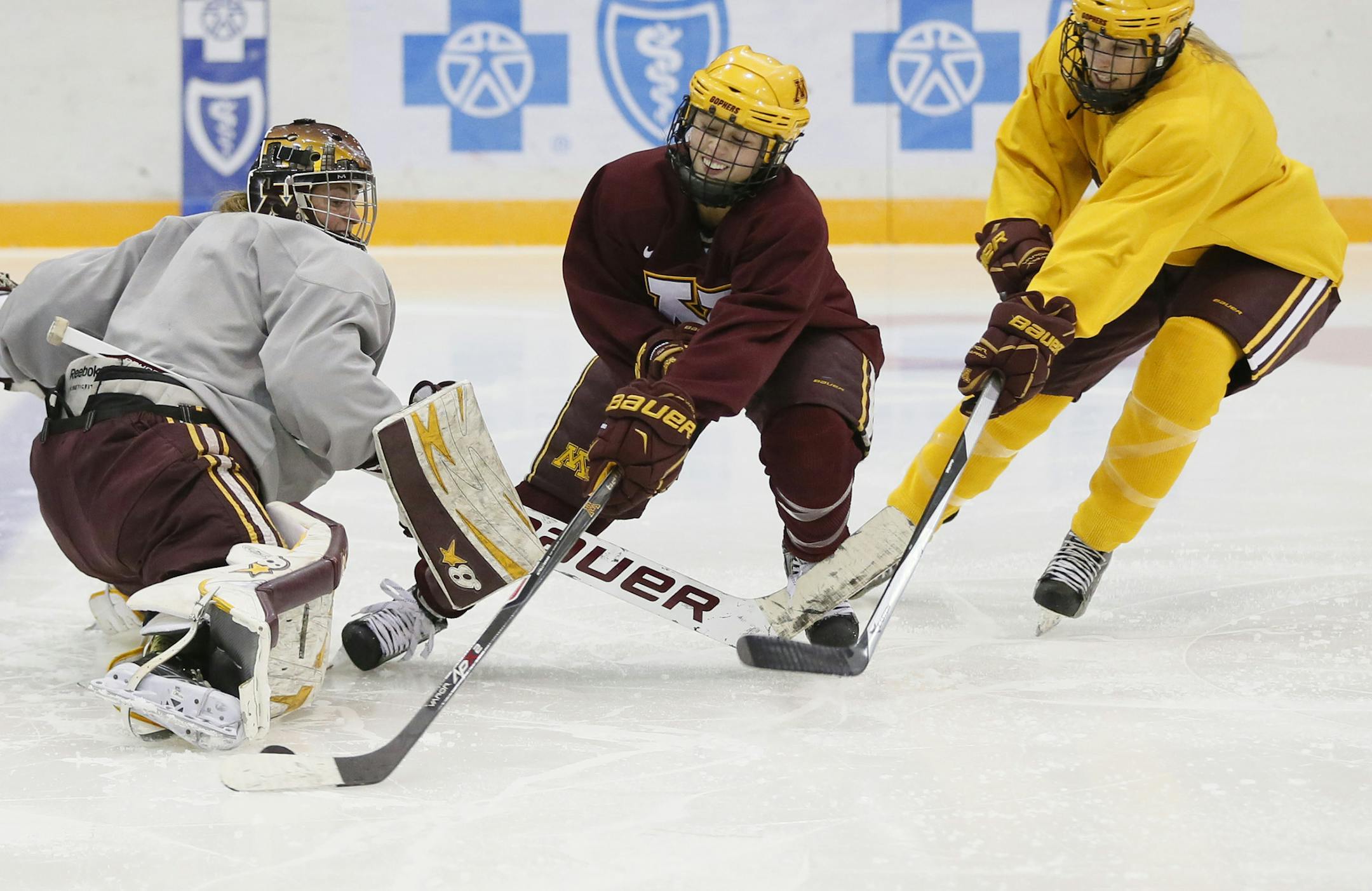 Rachael Bona center shoots the puck around a teammate during practice .The University of Minnesota women's hockey team practiced Tuesday September 30 , 2014 at Ridder Arena in Minneapolis ,MN. ] Jerry Holt Jerry.holt@startribune.com
