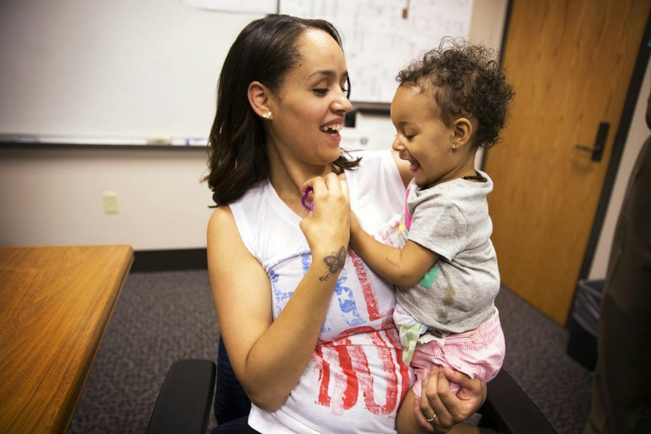 Shandrea Spielman, 22, and her daughter Eden spend time together while meeting with the media at the Minneapolis Police Department headquarters in Minneapolis on Friday, June 26, 2015.