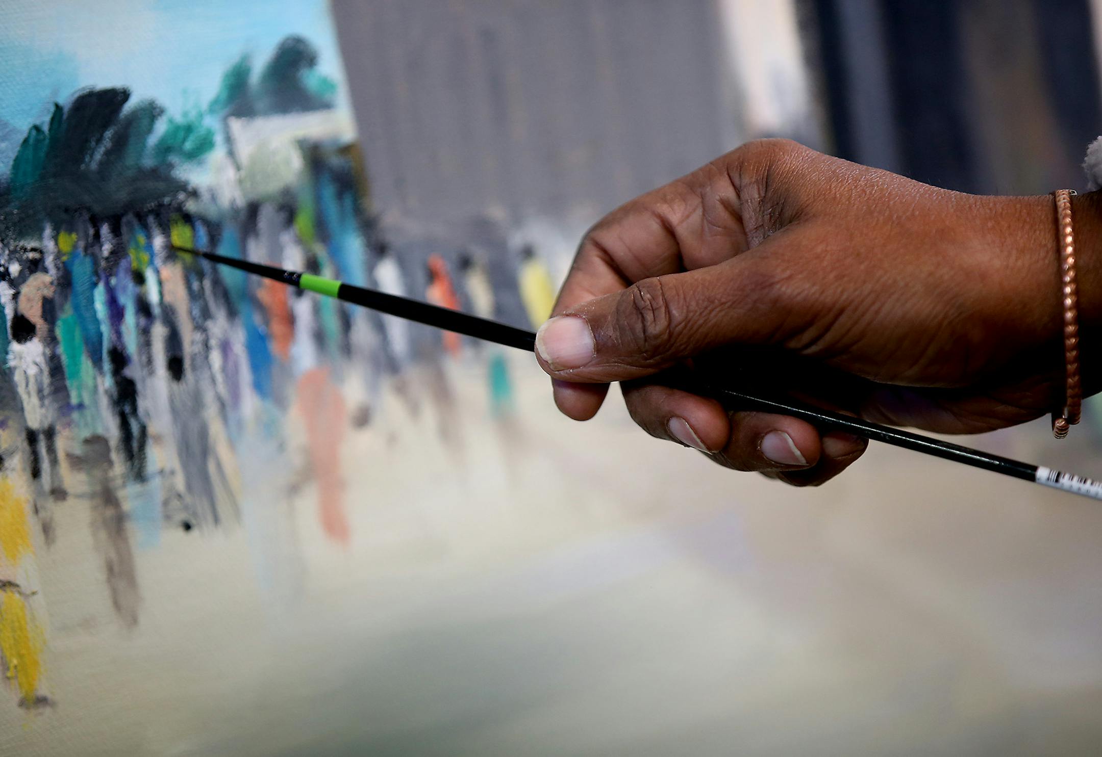 Abdulasis, also known as Aziz, worked on a piece from his home art studio, Friday, May 22, 2015. A lot of his art is hanging at his Columbia Heights home and has a mural at the Midtown Global Market in Minneapolis. ] (ELIZABETH FLORES/STAR TRIBUNE) ELIZABETH FLORES • eflores@startribune.com