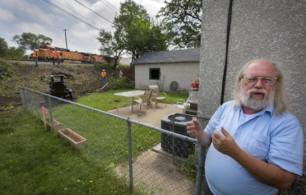 Longtime neighborhood resident Dennis Rusinko observed a railroad work crew cutting down trees along the backyard of a neighbor's home.