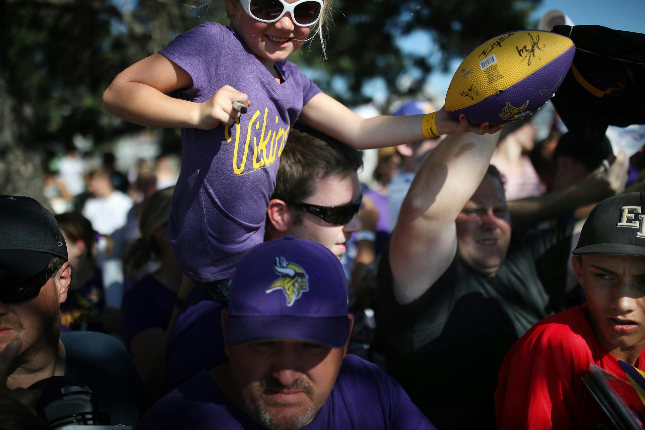 Allison Ditlevson 4, sat on her father Cameron Ditlevson shoulders tried to get autographs at Minnesota State University Mankato Saturday July 29, 2017 in Mankato , MN.