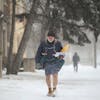 Mel Peterson delivers mail along his route on a snowy afternoon in Minneapolis in 2018.