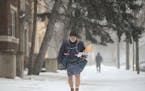 Mel Peterson delivers mail along his route on a snowy afternoon in Minneapolis in 2018.
