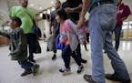 A group of immigrants from Honduras and Guatemala seeking asylum arrive at the bus station after they were processed and released by U.S. Customs and 