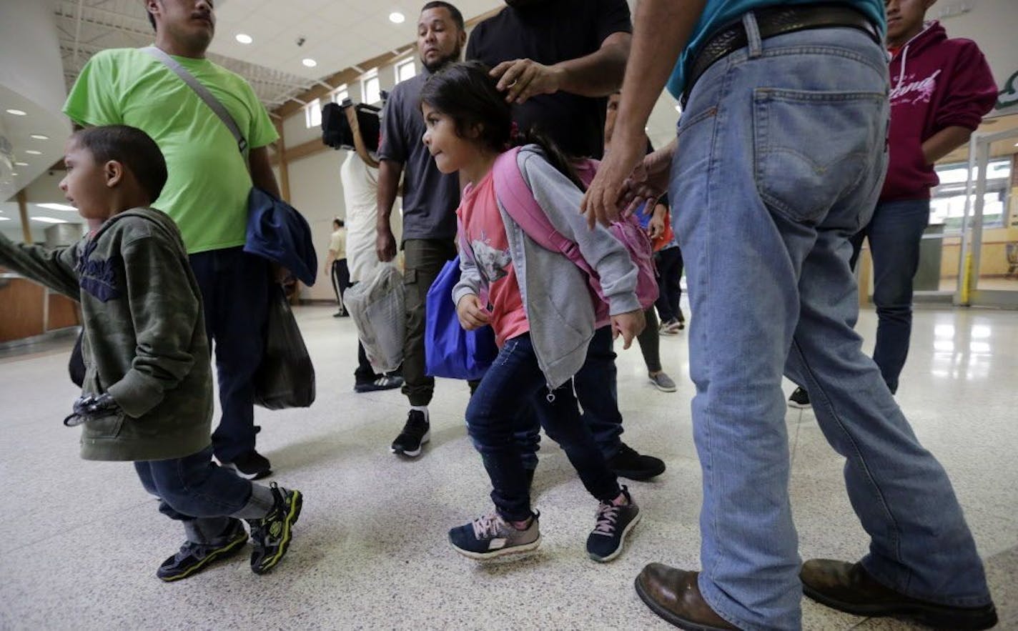 A group of immigrants from Honduras and Guatemala seeking asylum arrive at the bus station after they were processed and released by U.S. Customs and Border Protection, Thursday, June 21, 2018, in McAllen, Texas. President Donald Trump signed an executive order to end family separations at the border.