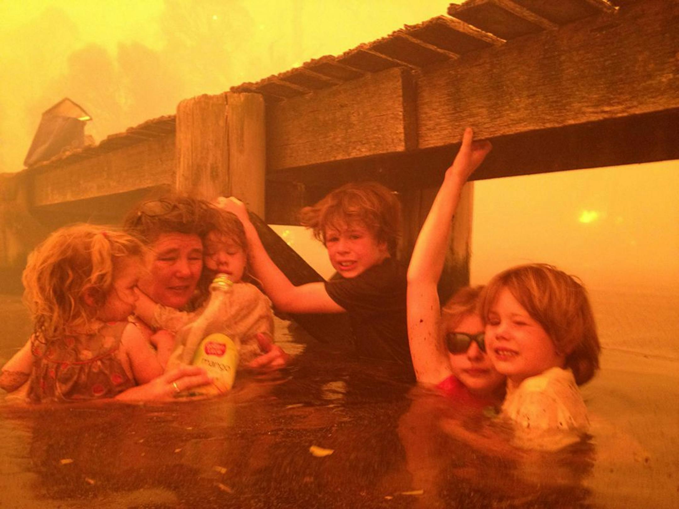 On Jan. 4, the ­Holmes family took refuge under a jetty as a wildfire raged in the Tasmanian town of Dunalley, east of the state capital of Hobart, Australia. Ninety homes were destroyed.