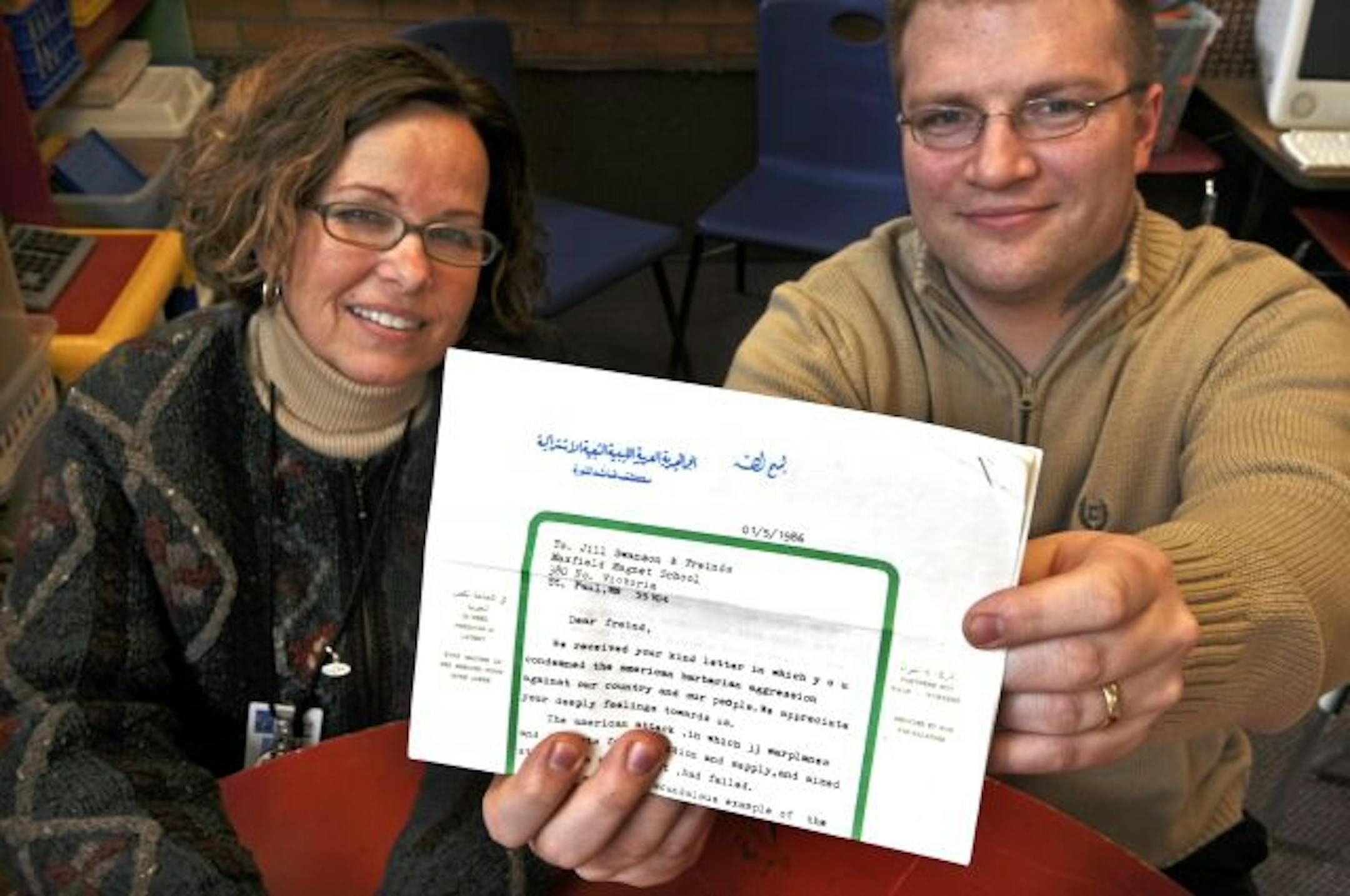 Jill Swanson and former student Aaron Heath held the letter that Gadhafi sent to her second-grade class in 1986.