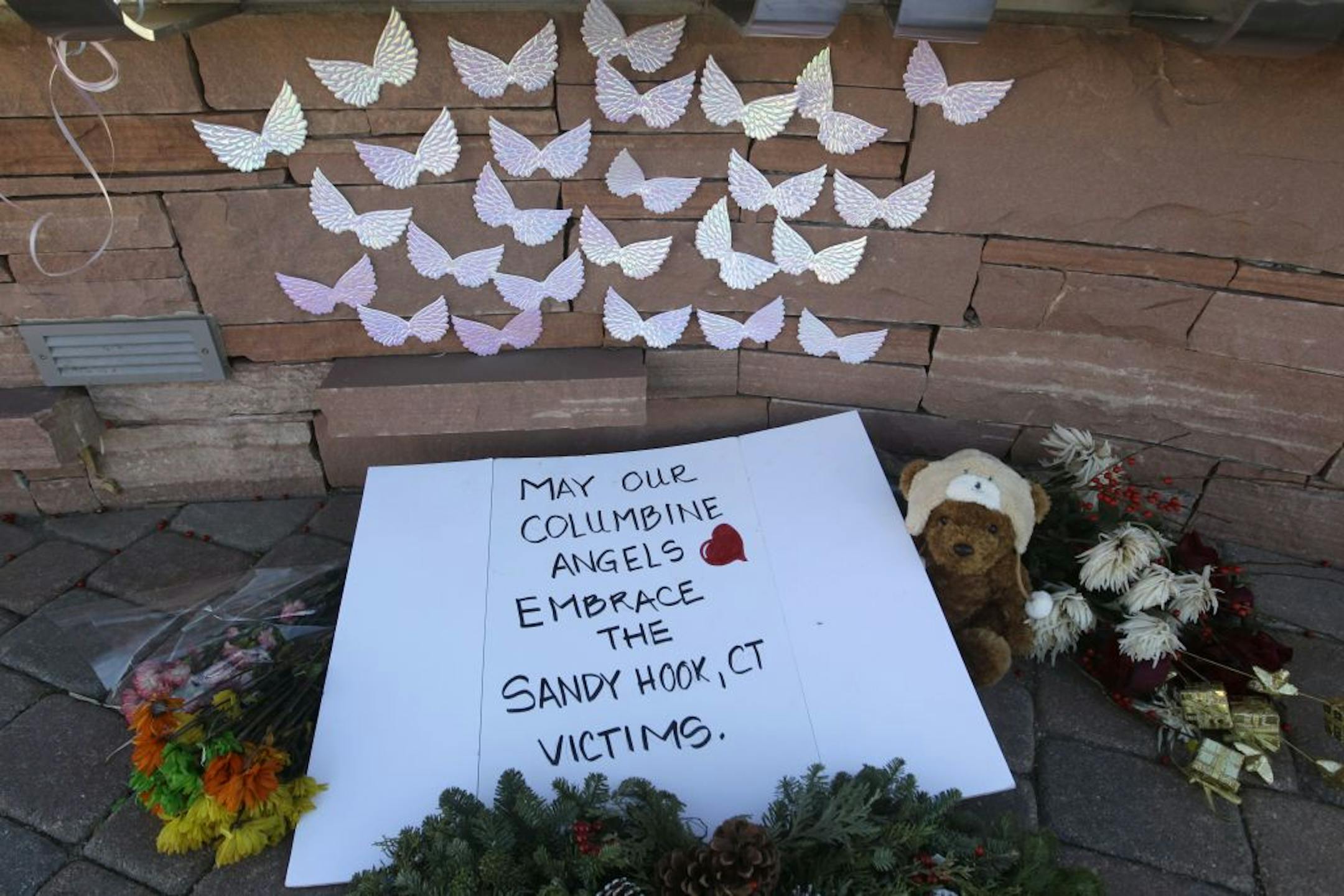 A note, flowers, and other items were left for the victims of last week's deadly shootings at a Connecticut elementary school, at a permanent memorial for those lost in the shootings at Columbine High School, in Littleton, Colo., Monday Dec. 17, 2012. Columbine and other sites of mass shootings have been rebuilt by residents determined to reclaim public places invaded by gunmen. Deciding what to do with the scene of a tragic event often determines how a community will heal.