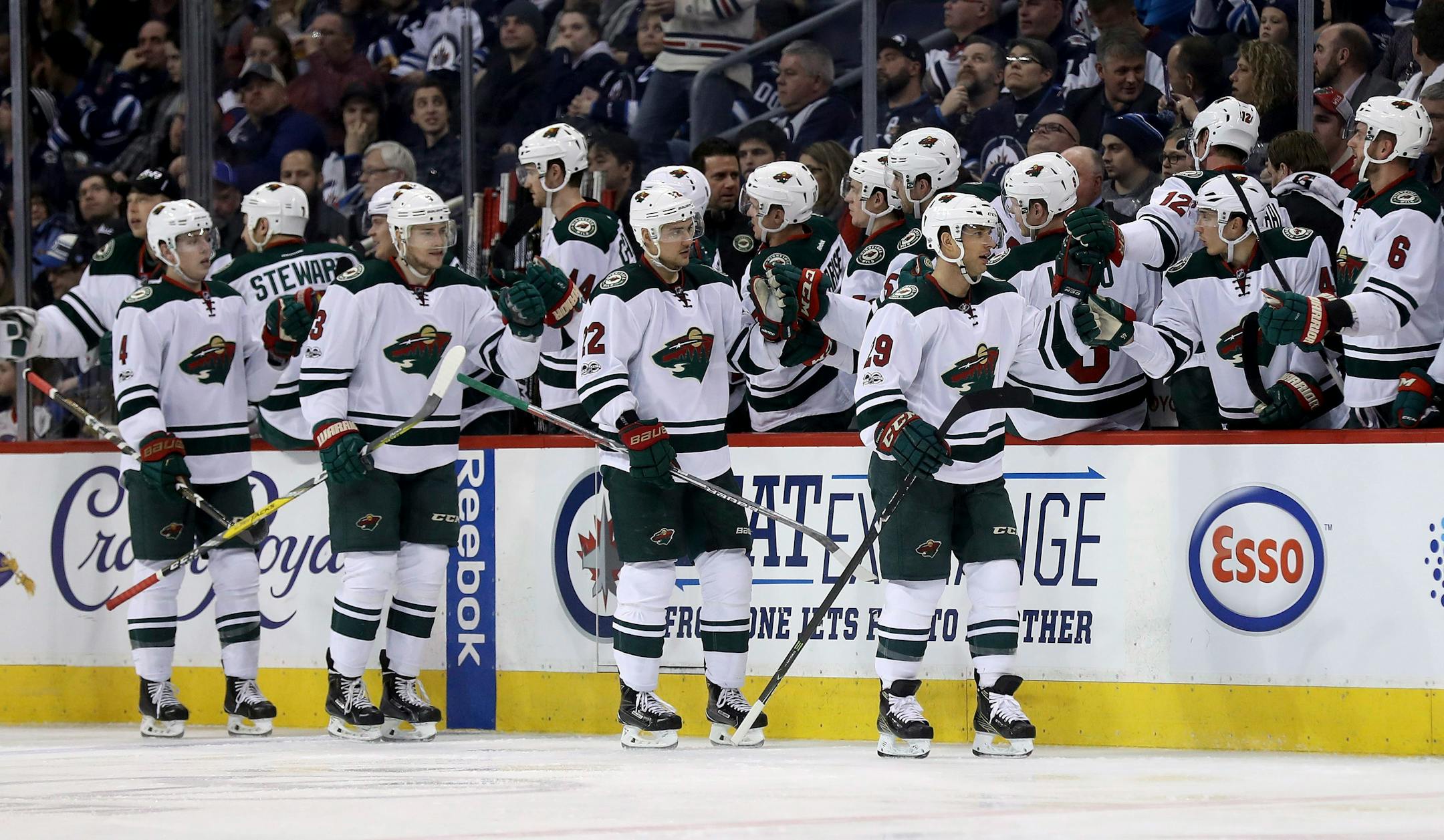 Minnesota Wild players celebrate a goal by Jason Pominville (29) against the Winnipeg Jets during the second period of an NHL hockey game Tuesday, Feb. 7, 2017, in Winnipeg, Manitoba. (Trevor Hagan/The Canadian Press via AP)