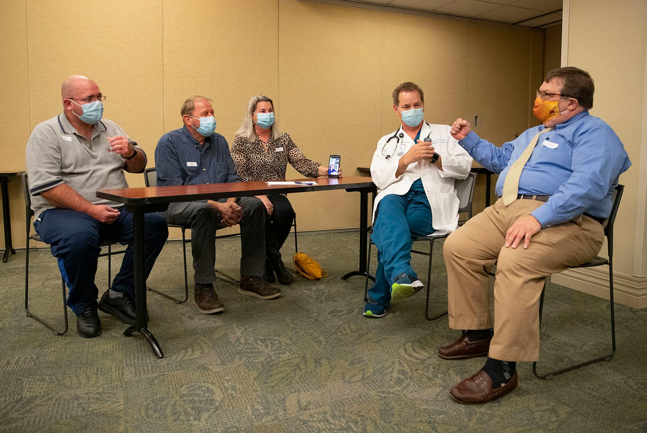 (From left) Tim White, Bob Schlicht, Kristine Smoley, Dr. David Ingbar, M.D. from the University of Minnesota and Dr. Tim Rich, M.D. from Essentia Health had a rou t table discussion about White and Schlicht's survival of ARDS and COVID-19. Smoley was also holding White's phone while his sister, Mary Ellen Evangelista, facetimed into the meeting at Essentia Health-St. Mary's Medical Center in Duluth on Friday October 16, 2020.