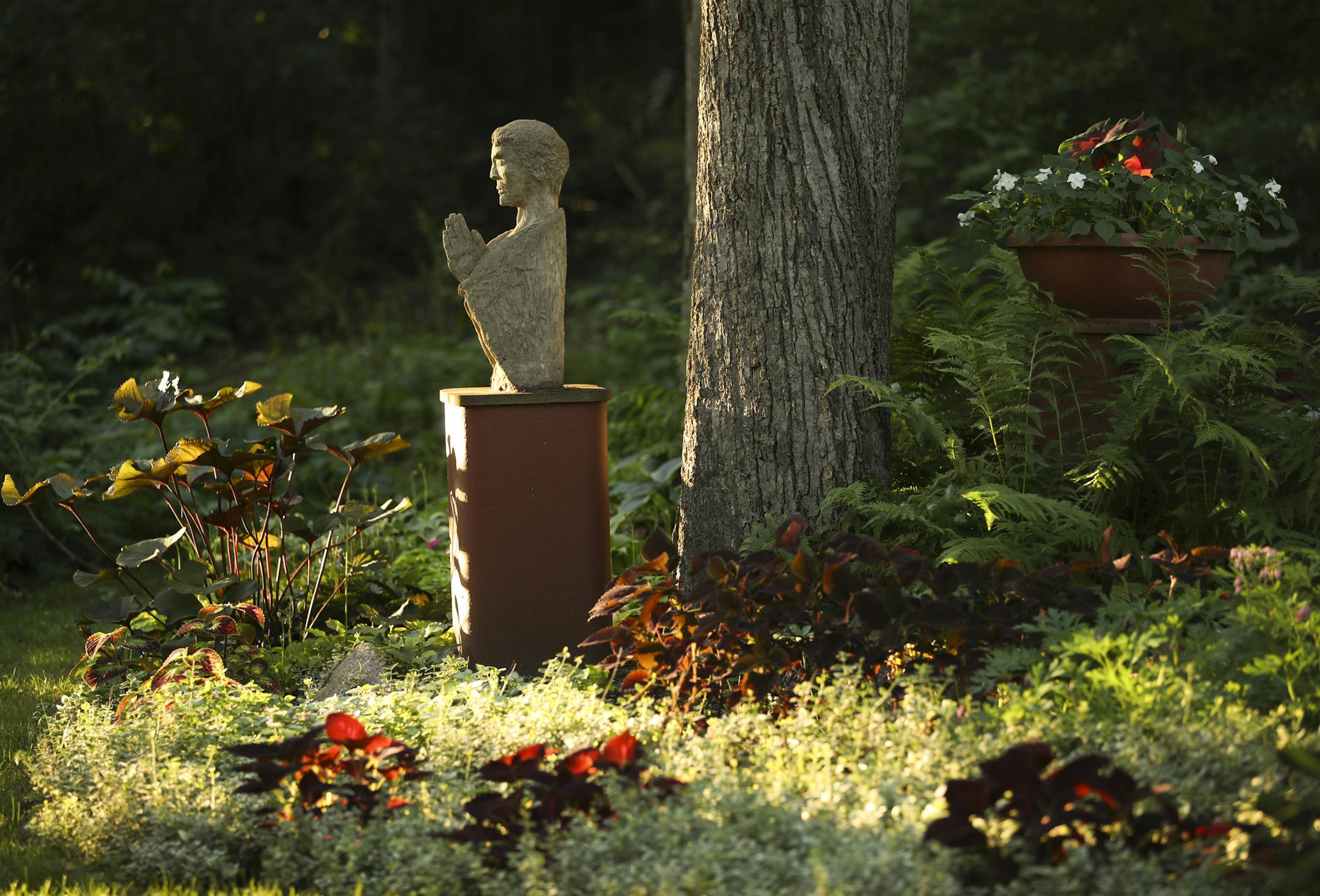 Gene Waldowski's artwork, including this statue, and creative hardscapes accent the couple's carefully composed shade garden.