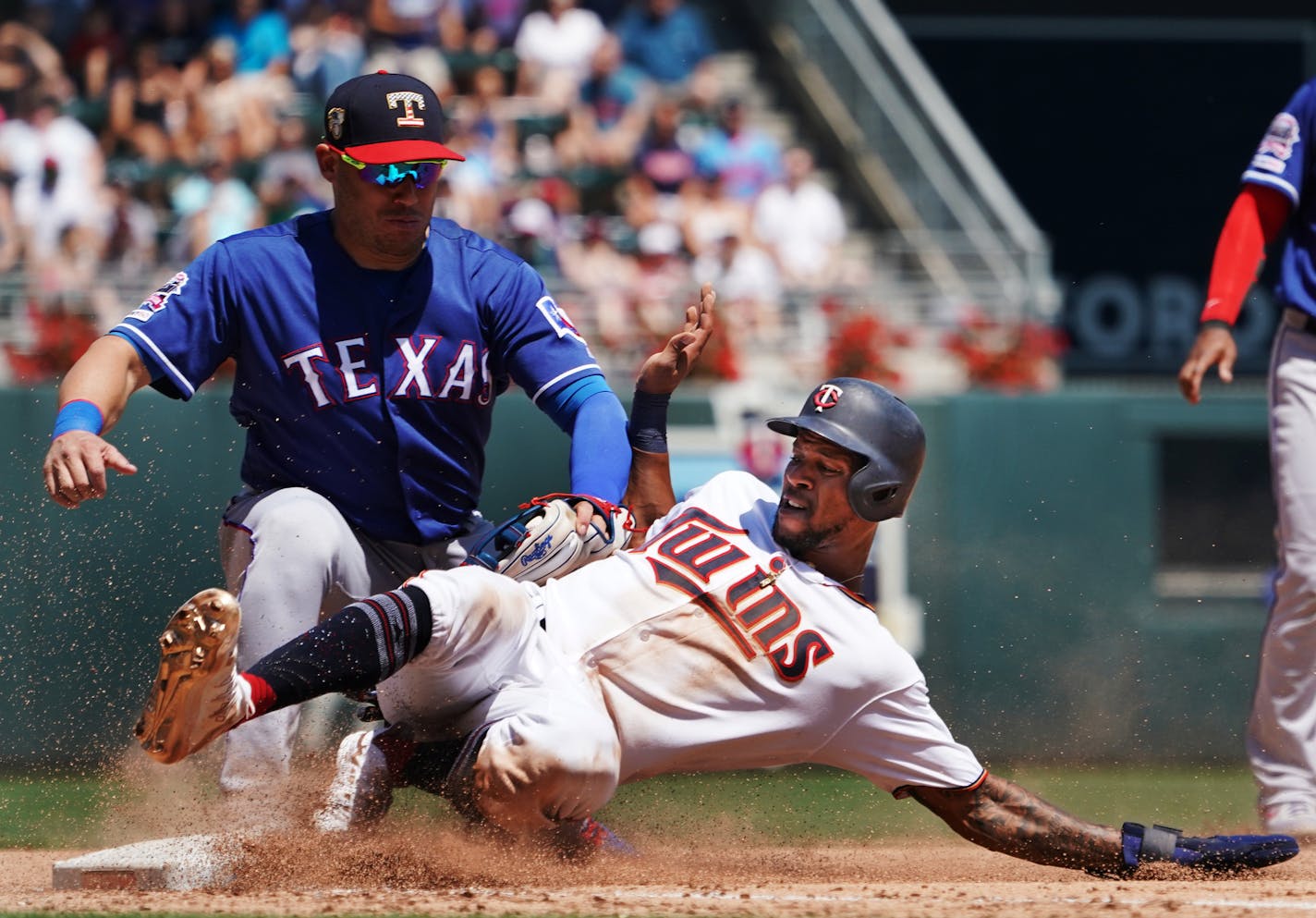 Twins Byron Buxton(25) is called safe at 3rd base on a triple as Asdrubal Cabrera applies the tag in the 2nd inning.] At Target Field, the Twins take on the Texas Rangers on 7/7/19. RICHARD TSONG-TAATARII &#xa5; richard.tsong-taatarii@startribune.com