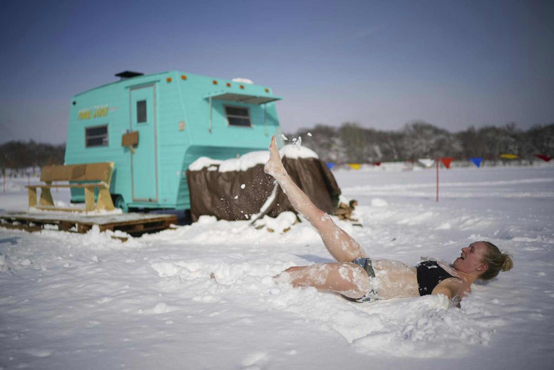 Ingrid Aune was ready to cool down after baking in the 200 degree heat of Nickolai Koivunen's MinneSauna on the ice of Lake Harriet as part of the Art Shanty Project Sunday morning.