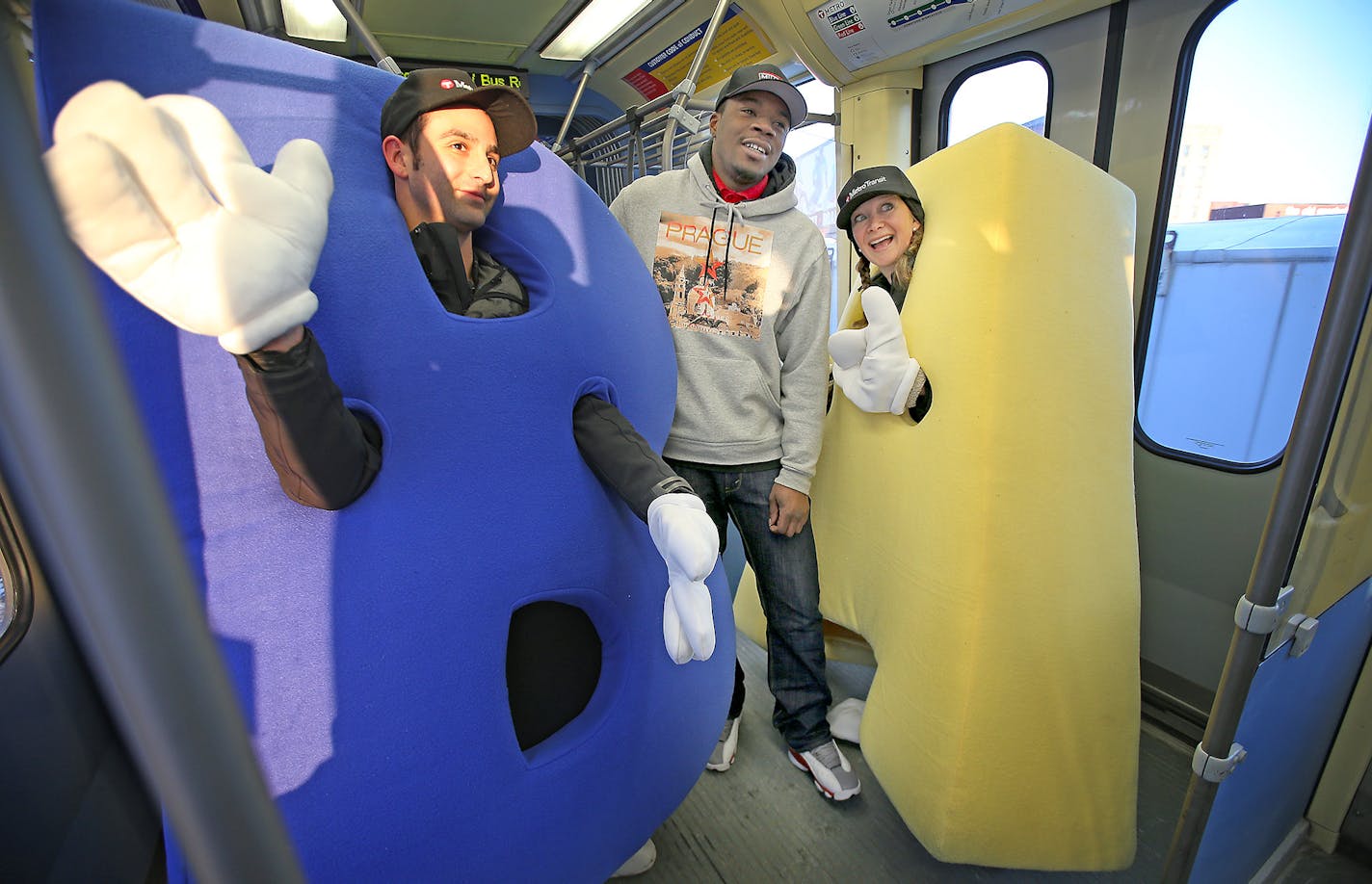 Metro Tansit's Adam Mehl, left, and Jessica Cross took a quick snapshot with Darius Bennett for Instagram and a chance to win $100 Blue Line card, Thursday, February 5, 2015. The Blue Line reached the 10 million rider mark and celebrated with a social media give away. ] (ELIZABETH FLORES/STAR TRIBUNE) ELIZABETH FLORES &#x2022; eflores@startribune.com