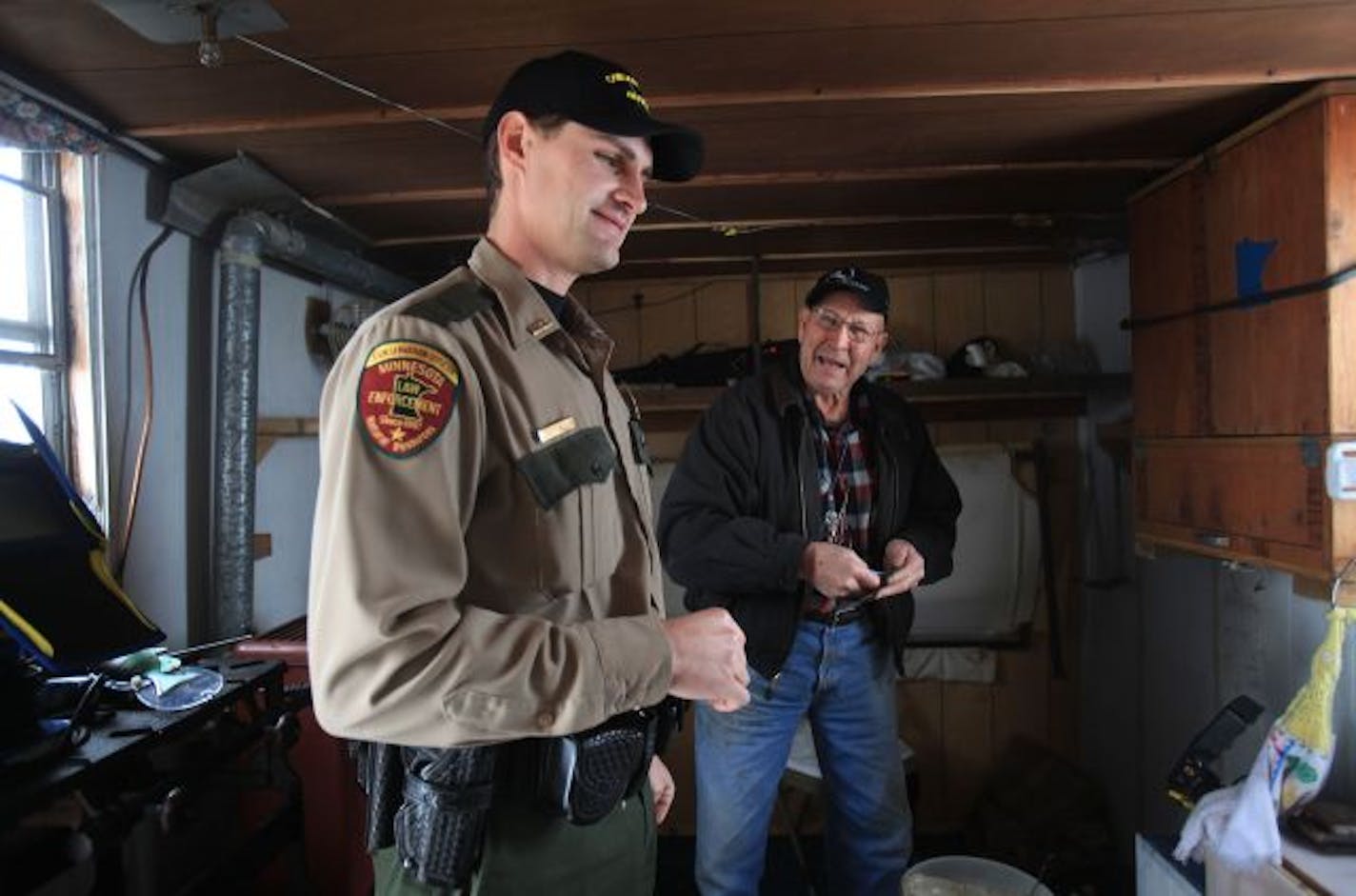 DNR conservation officer Adam Block joked with Rosemount resident Richard Cliff after checking his fishing license.