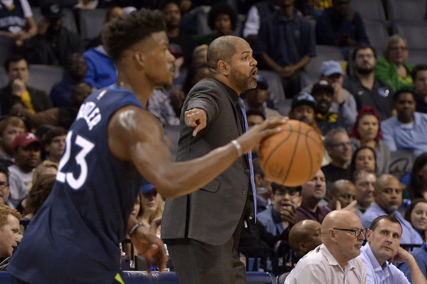 Memphis Grizzlies interim head coach J.B. Bickerstaff, center, calls to players as Minnesota Timberwolves guard Jimmy Butler (23) moves the ball downcourt in the second half of an NBA basketball game Monday, Dec. 4, 2017, in Memphis, Tenn. (AP Photo/Brandon Dill)