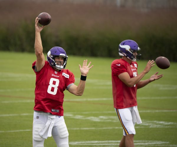 Vikings quarterback Kirk Cousins (8) throwing during practice with teammate Nate Stanley (7) at right.