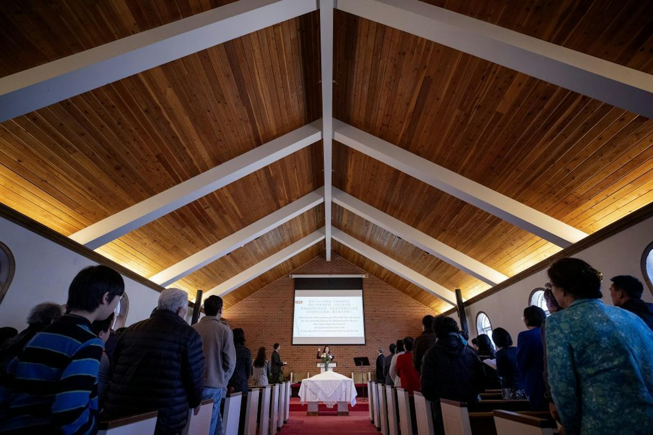 A song leader led a hymn at a Minnesota Mandarin Christian Church service, which is held in the chapel at the Christ Presbyterian Church in Edina.