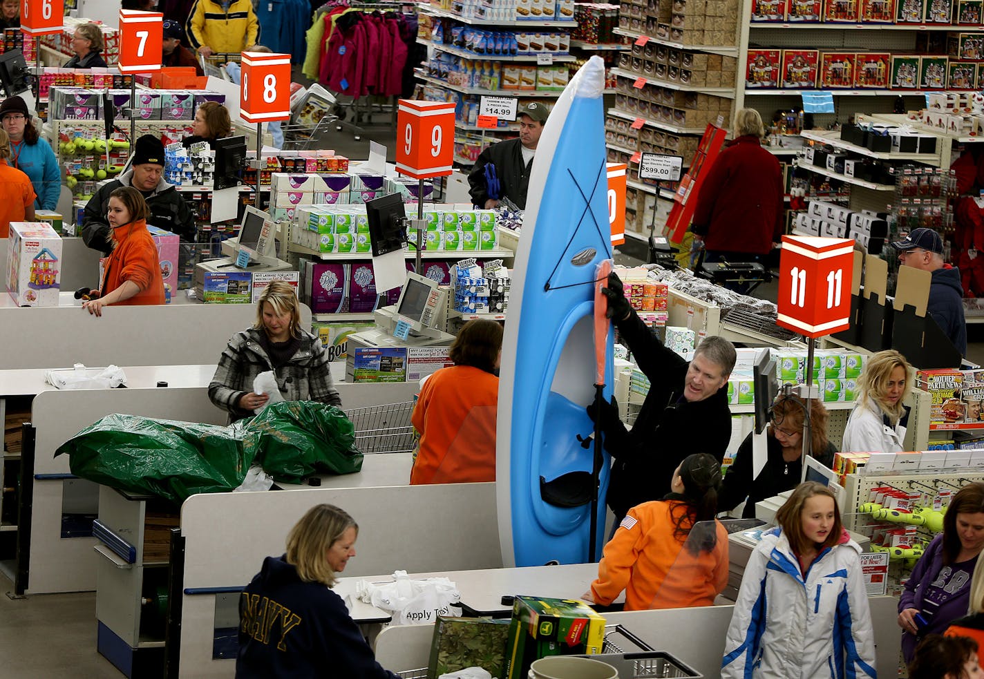 Rob Kerber was happy with his bargain kayak as he and his wife, Jane Kerber, checked out during "Black Friday" shopping at Mills Fleet Farm in Oakdale in 2013.