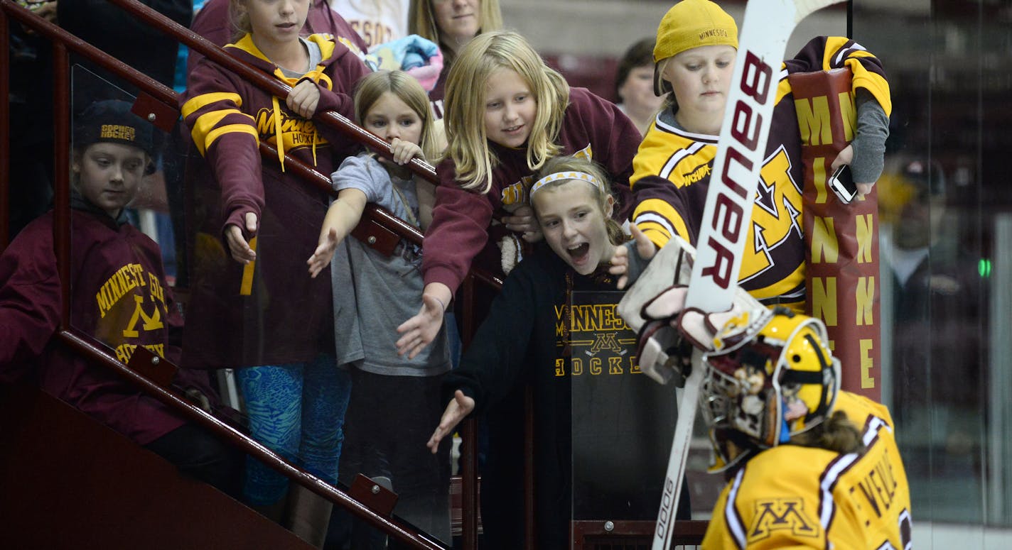 Young gophers fans reached in for a high five from University of Minnesota goalie Amanda Leveille (29) as she left the ice after Friday night's 7-0 victory over St. Cloud State University. ] Aaron Lavinsky &#x2022; aaron.lavinsky@startribune.com The University of Minnesota Golden Gophers women's hockey team played the St. Cloud State University Huskies on Friday, Oct. 9, 2015 at Ridder Arena.