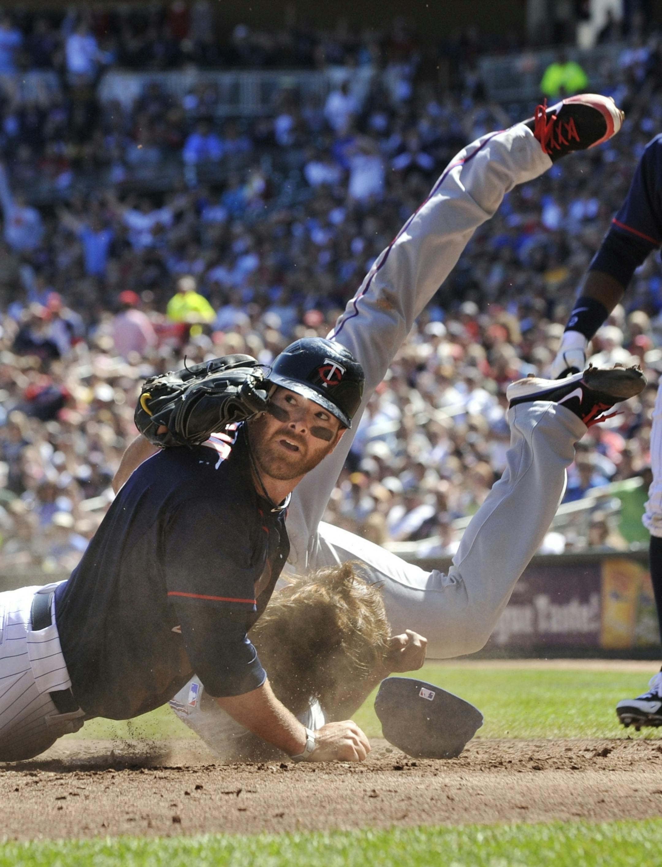 Rangers pitcher Yu Darvish gets flipped in a collision with the Twins' Ryan Doumit, left, as he tagged Doumit, who attempted to score on a fielder's choice in 2012.
