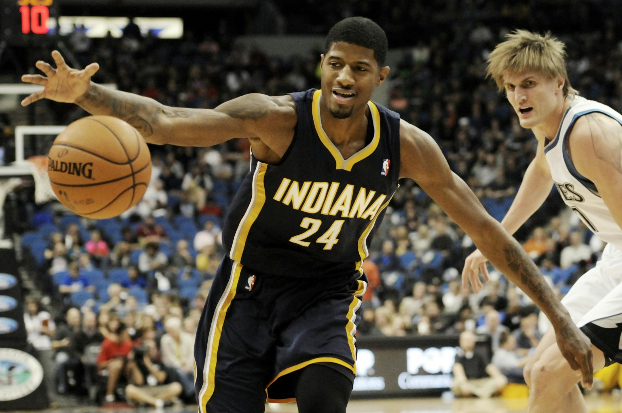 Indiana Pacers' Paul George cannot control the ball in bounds as Minnesota Timberwolves' Andrei Kirilenko, right, of Russia, defends in the first half of an NBA basketball game, Friday, Nov. 9, 2012, in Minneapolis.