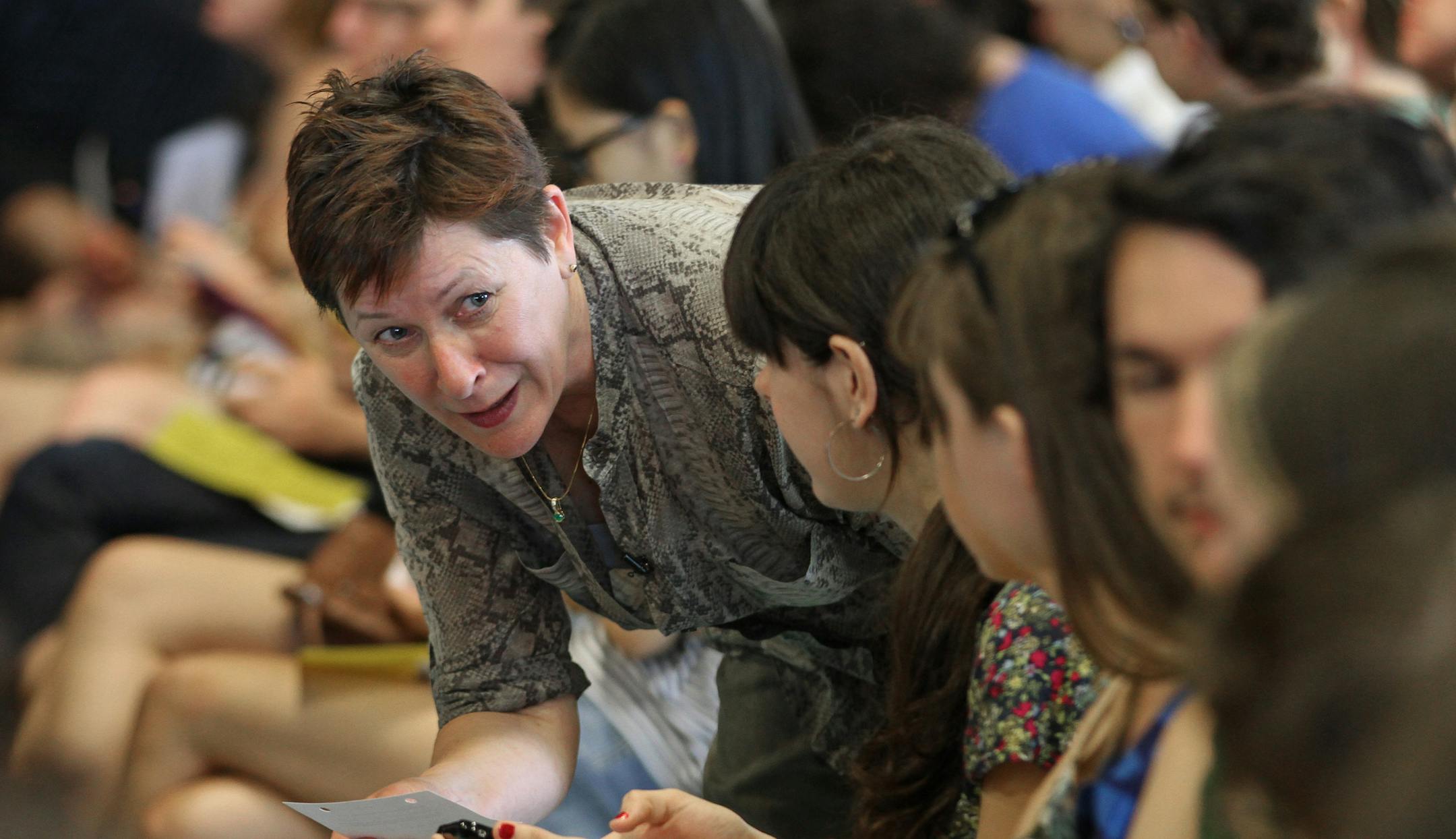 (left) Macalester College Registar Jayne Niemi checked with students on the pronunciation of their names during graduation rehearsal at the field house on 5/16/13. Reading students' names at graduation is an art, and Macalester College's registrar, Jayne Niemi, has perfected it. This year, she'll read 533 names with ease and accuracy. Some provosts just stumble through, but Niemi studies the names, listening to recordings of the international students, checking in with the linguistics department