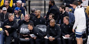 Chris Finch gives instructions during Game 1 against Denver from his chair in the second row behind the Timberwolves bench. "It worked out better than