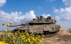 Israeli soldiers drive a tank on the border with Gaza Strip, in southern Israel, on Tuesday, March 19, 2024. The army is battling Palestinian militant