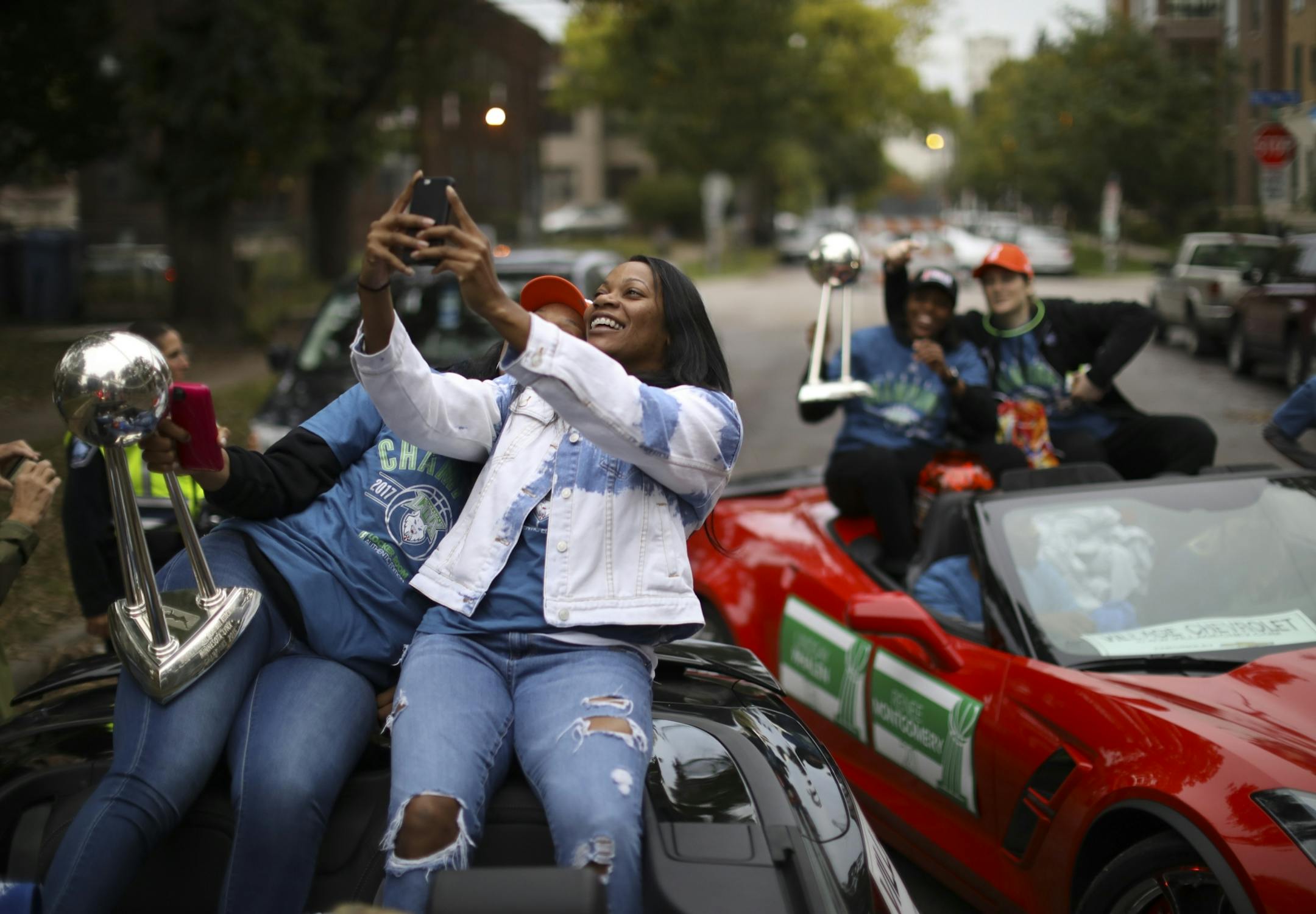 Lynx forward Plenette Pierson and guard Jia Perkins, right, posed for selfie while Renee Montgomery and Lindsay Whalen mugged behind them as they waited for the parade to start.