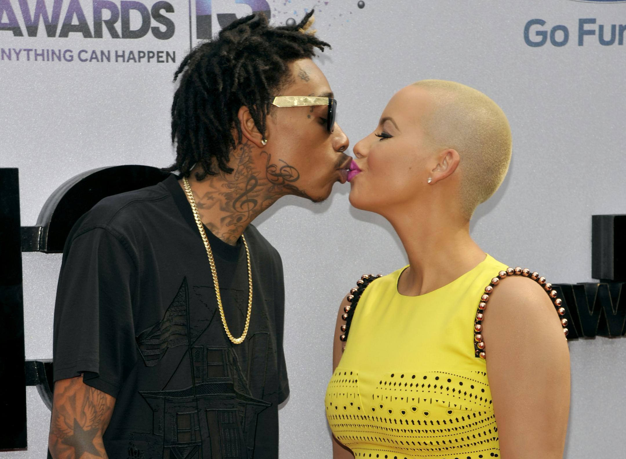 Wiz Khalifa, left, and Amber Rose kiss at the BET Awards.