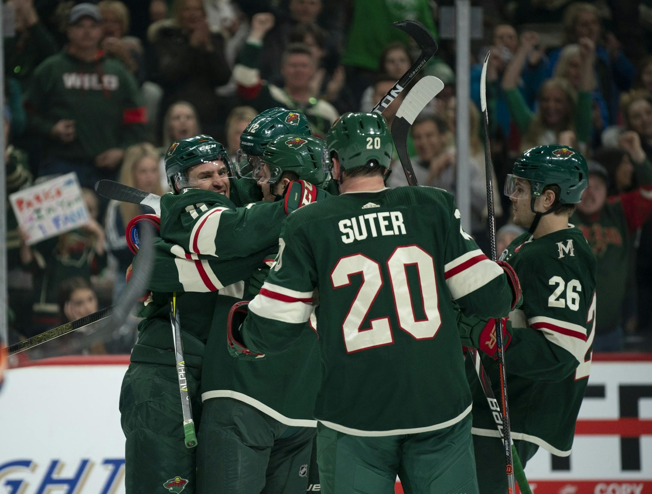 Minnesota Wild left wing Zach Parise (11) was congratulated by his line mates after his second period goal tied the game 1-1.