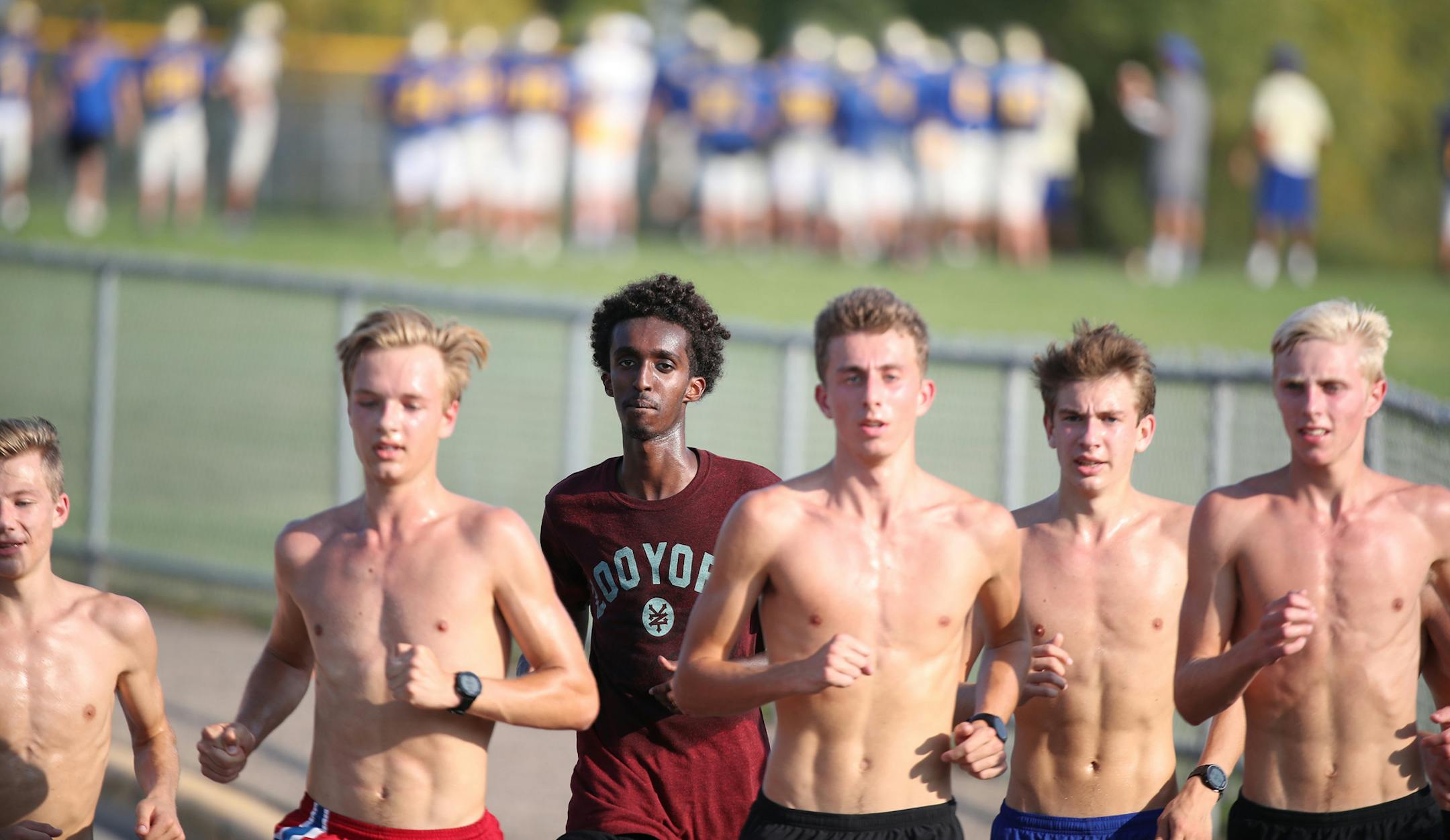 Khalid Hussein center (with shirt on) and Grant Price (far right ) and other members of the Wayzata high cross county team worked out at Wayzata High School Tuesday September 12,2017 in Plymouth, MN. ] JERRY HOLT ï jerry.holt@startribune.com