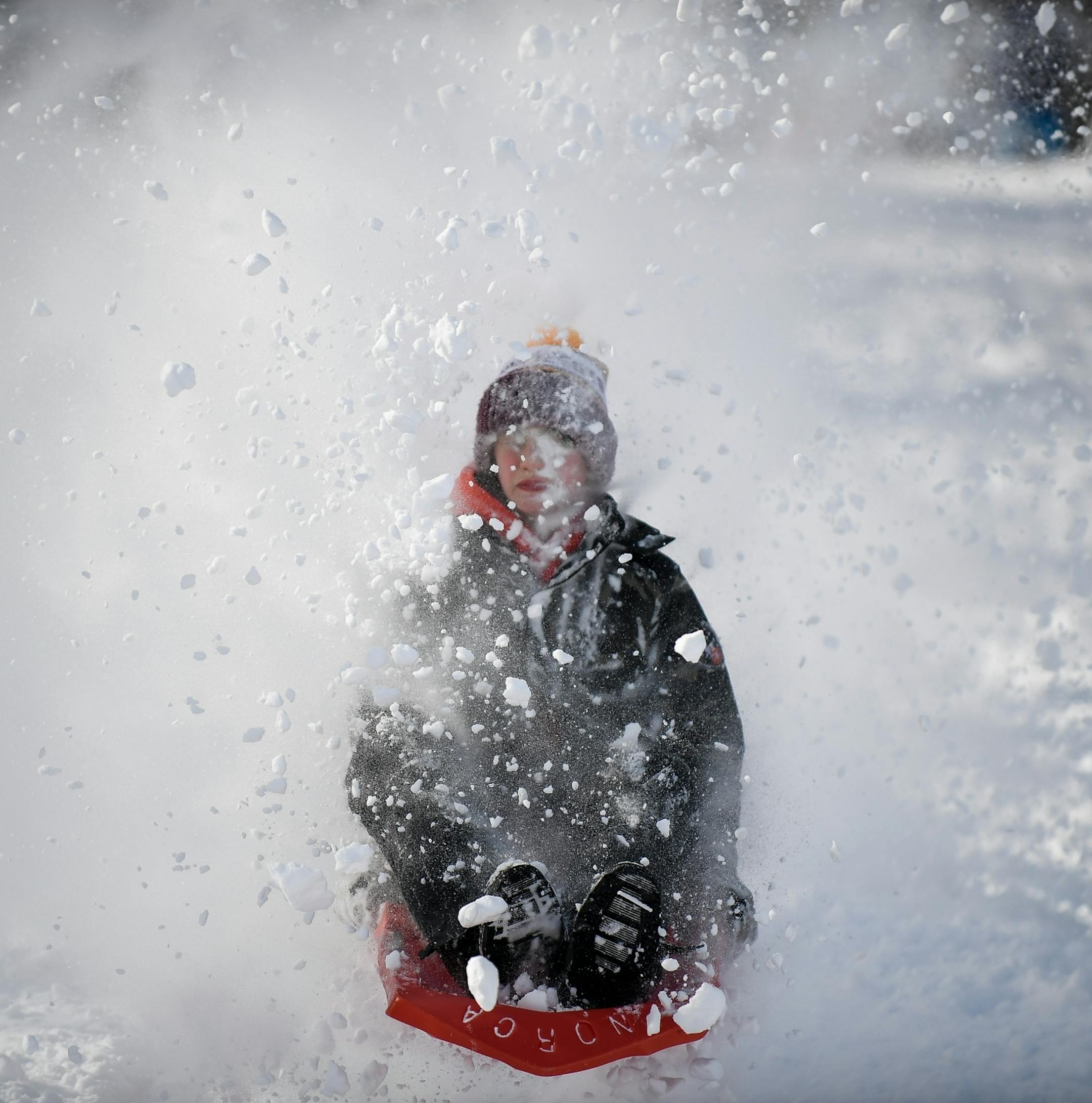 A child caught some snow in the face while sledding at Beard's Plaisance Tuesday.