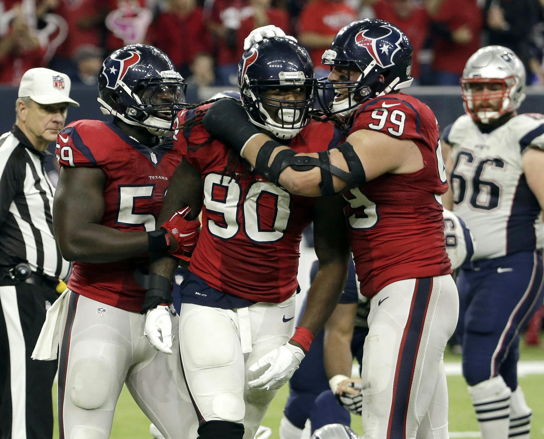 Houston Texans' Whitney Mercilus (59) and J.J. Watt (99) celebrate with Jadeveon Clowney (90) after Clowney sacked New England Patriots quarterback Tom Brady (12) during the second half of an NFL football game, Sunday, Dec. 13, 2015, in Houston. (AP Photo/David J. Phillip) ORG XMIT: TXEG