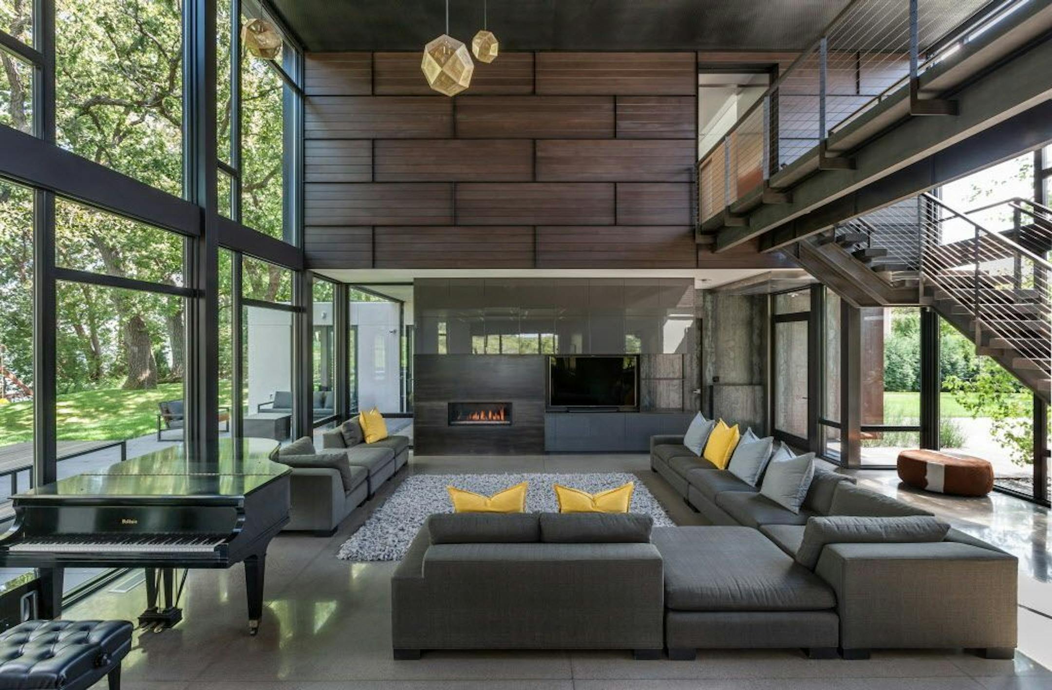 An industrial modern home for a big family has open and multifunctional spaces of indestructible materials, by architect Tim Alt.