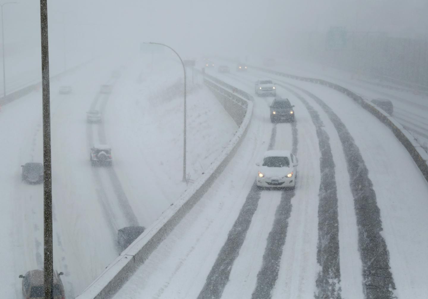 Cars make their way slowly on Interstate 35W in Minneapolis as the Twin Cities fell under a blizzard warning.