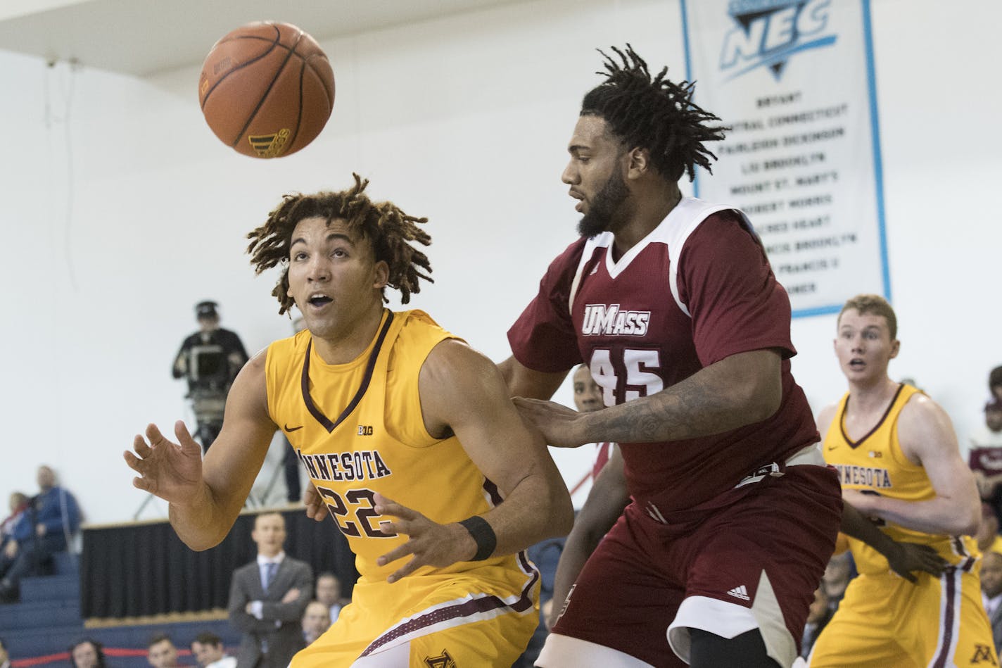 UMass center Rashaan Holloway (45) and Minnesota center Reggie Lynch (22) fight for a loose ball during the first half of an NCAA college basketball game, Friday, Nov. 24, 2017, in New York. (AP Photo/Mary Altaffer)