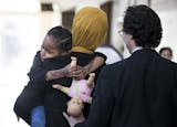 Mushkaad Abdi, 4, held tight to her mother Samira Dahir after a press conference about the process of getting Mushkaad approved to join her mother in the U.S. at Lutheran Social Services in Minneapolis, Minn., on Friday, February 3, 2017.