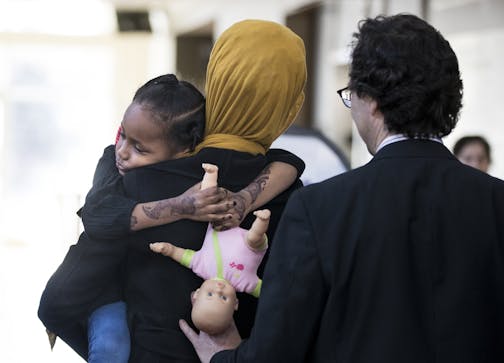 Mushkaad Abdi, 4, held tight to her mother Samira Dahir after a press conference about the process of getting Mushkaad approved to join her mother in the U.S. at Lutheran Social Services in Minneapolis, Minn., on Friday, February 3, 2017.