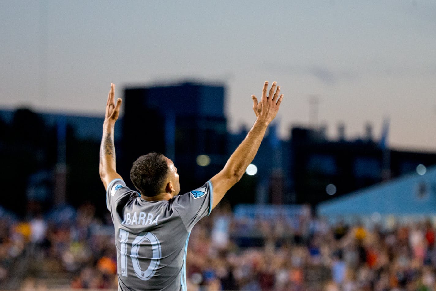 Minnesota United's Miguel Ibarra raises his arms after scoring the final goal during the second half against D.C. United on Saturday, July 29, 2017, at TCF Bank Stadium