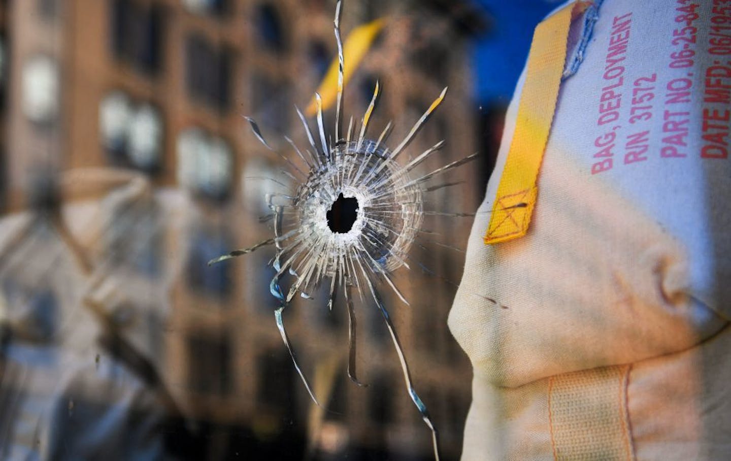 Two bullet holes in the glass of Jumpwings Heritage Brands Clothing store at 28 N 4th St right across the street from a police station.