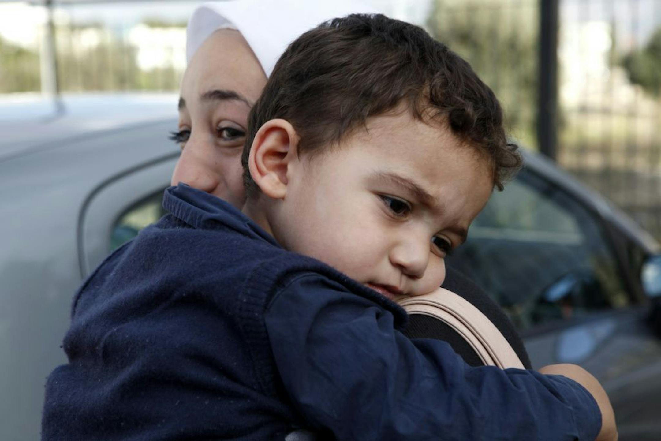 Bushr Al Tawashi, as he is carried by his mother Arin Al Dakkar, outside of a private Sigma TV station, in Nicosia, Cyprus, Friday, Oct. 26, 2012. A 2-year-old Syrian boy who was believed dead after his family inadvertently left him behind as they fled shelling in Damascus last summer has been reunited with his parents in Cyprus, a lawyer said. "You can imagine how they felt when they were told their son was alive after bearing all this guilt thinking that he was dead," lawyer Stella Constantino
