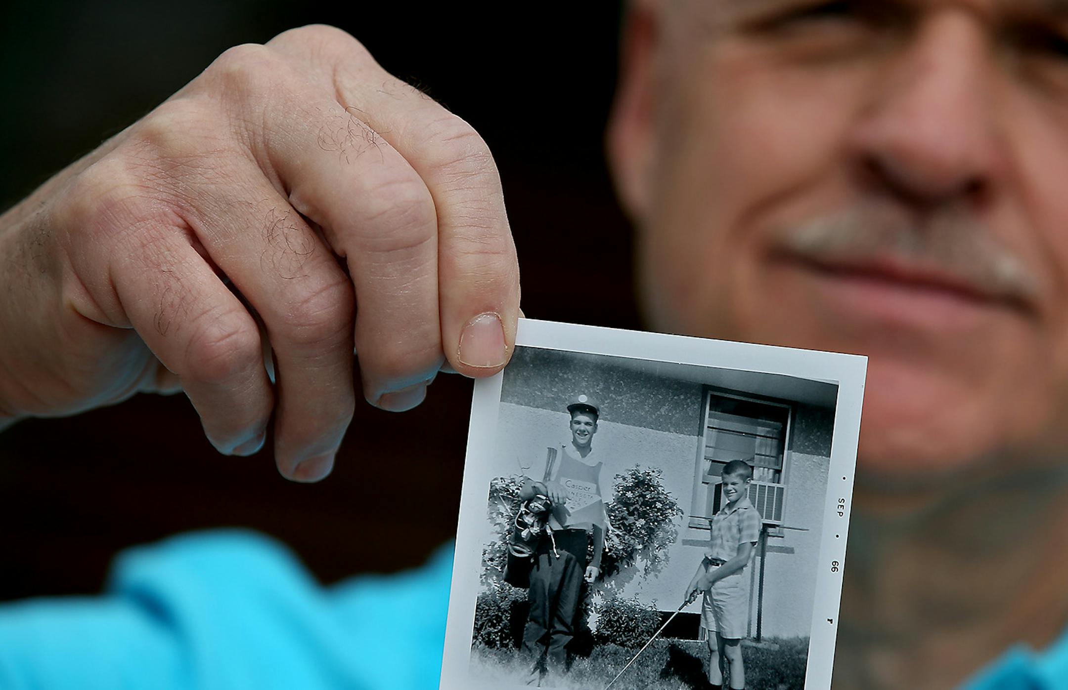 Mark Kinderwater showed a photo of himself from his days as a caddie in the 1960s. His father was a member at Midland Hills.