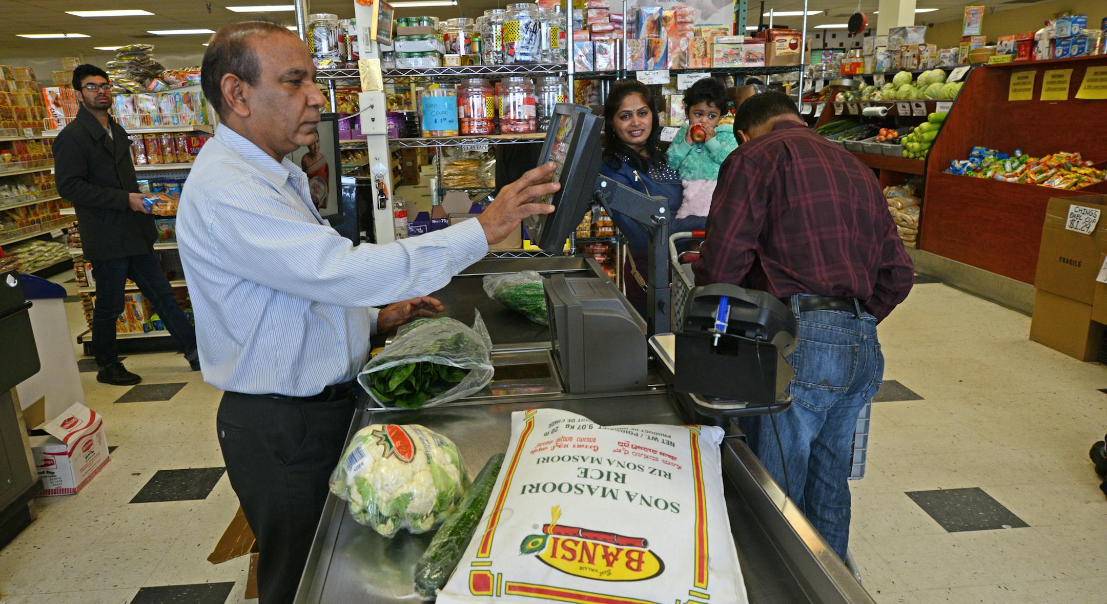 Anil Patel worked behind the register at Pooja Grocers that he owns and which specializes in Indo-Pak groceries and fresh vegetables.] Ethnic restaurants and grocery stores line Central Avenue in Columbia Heights, drawing community members and commuters alike to sample different cultures' cuisines. Richard.Sennott@startribune.com Richard Sennott/Star Tribune Columbia Heights , Minn. Tuesday 3/11/2014) ** (cq)