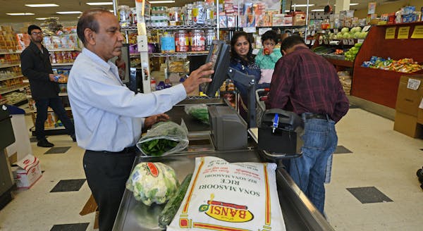 Anil Patel worked behind the register at Pooja Grocers that he owns and which specializes in Indo-Pak groceries and fresh vegetables.] Ethnic restaura