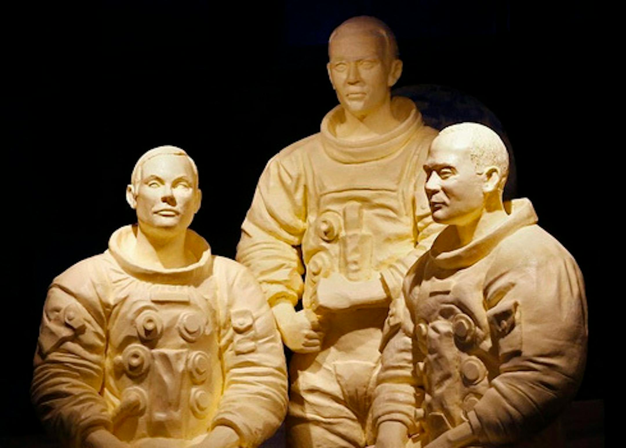 This Tuesday, July 23, 2019, photo shows a sculpture of Apollo 11 astronauts and the butter cow among the latest Ohio State Fair butter sculptures after the sculptures were unveiled in Columbus, Ohio. (Fred Squillante/The Columbus Dispatch via AP)